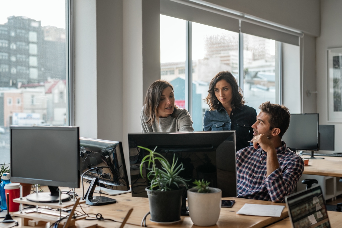 Team at work looking at computer for link building lies