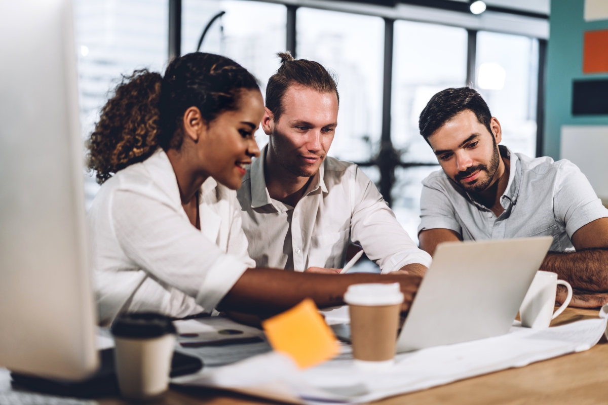 Team of three at desk looking up how to Leverage Long-Tail Keywords to Boost SEO & Affiliate Earnings